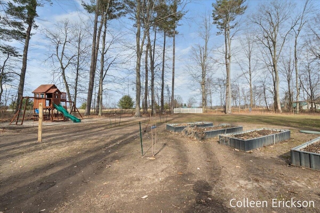 view of yard featuring a garden and playground community