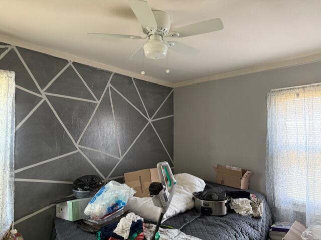 bedroom with crown molding and ceiling fan