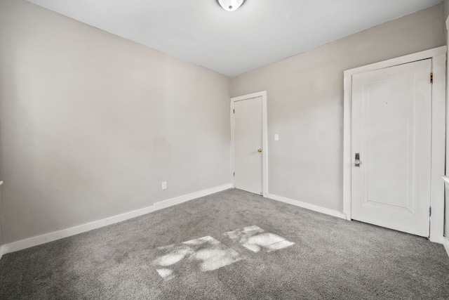 carpeted empty room with baseboards