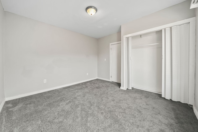 unfurnished bedroom featuring baseboards, a closet, and carpet floors