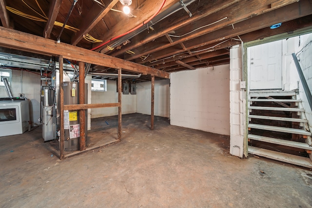 below grade area featuring washer / dryer, gas water heater, and water heater