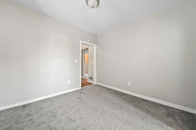 unfurnished room featuring baseboards and carpet floors