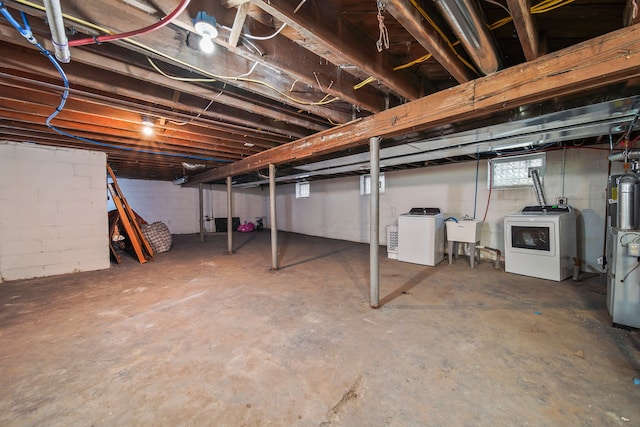 basement with washer / clothes dryer and a sink