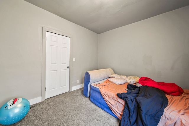 bedroom featuring baseboards and carpet