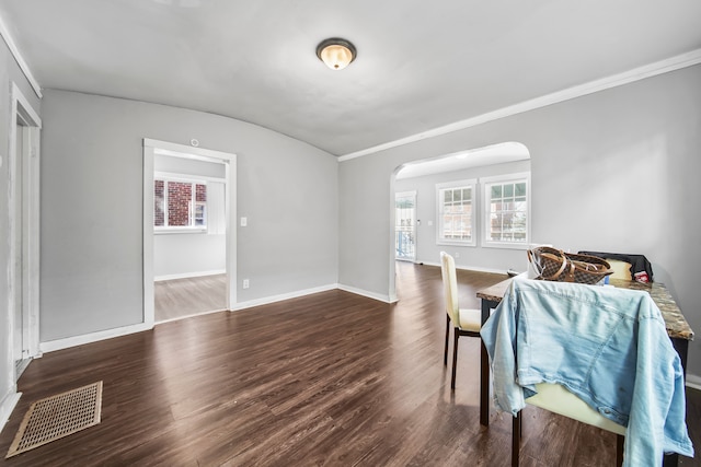 dining area with visible vents, arched walkways, a healthy amount of sunlight, and wood finished floors