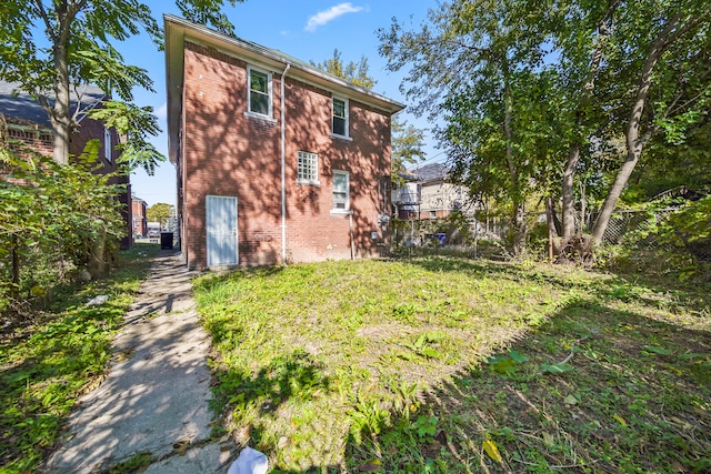 back of property with brick siding and fence