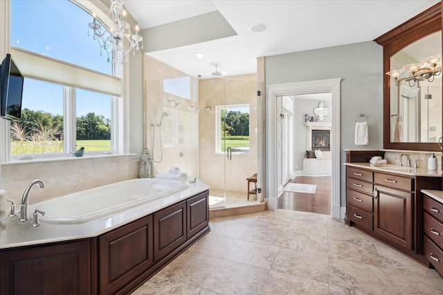 2122 Grange Rd, Buchanan, MI 49107 - bathroom with a chandelier, a stall shower, a bath, and vanity