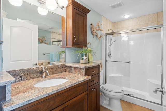 2122 Grange Rd, Buchanan, MI 49107 - bathroom with a shower stall, toilet, vanity, and tile patterned flooring