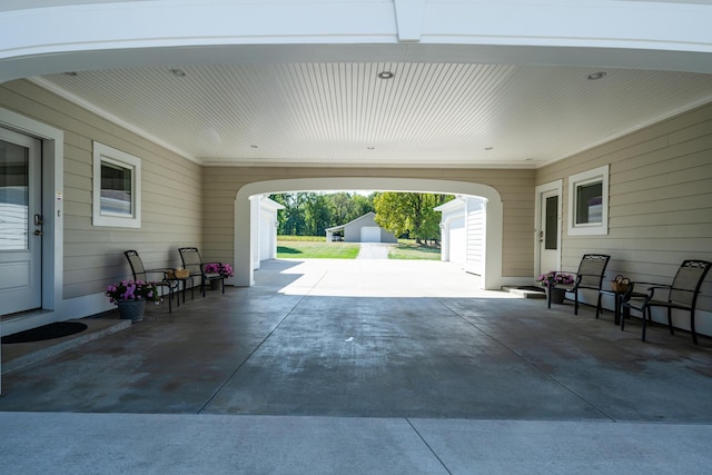 2122 Grange Rd, Buchanan, MI 49107 - view of patio featuring concrete driveway and an attached carport