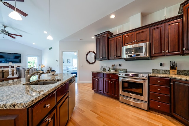 2122 Grange Rd, Buchanan, MI 49107 - kitchen featuring stainless steel appliances, a sink, ceiling fan, light wood-type flooring, and light stone counters