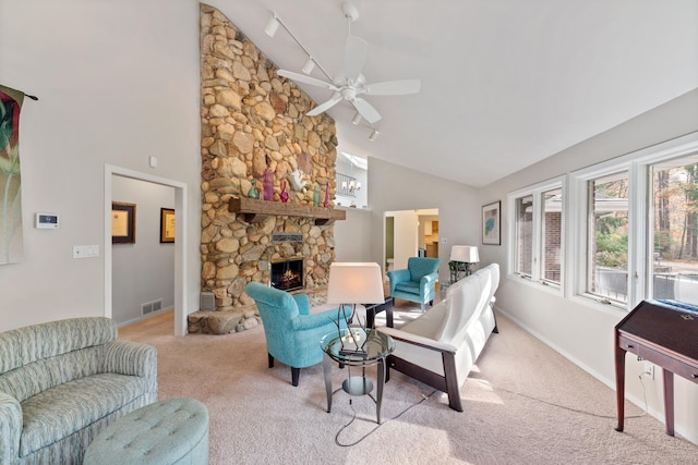 living room with a ceiling fan, visible vents, baseboards, a fireplace, and carpet flooring