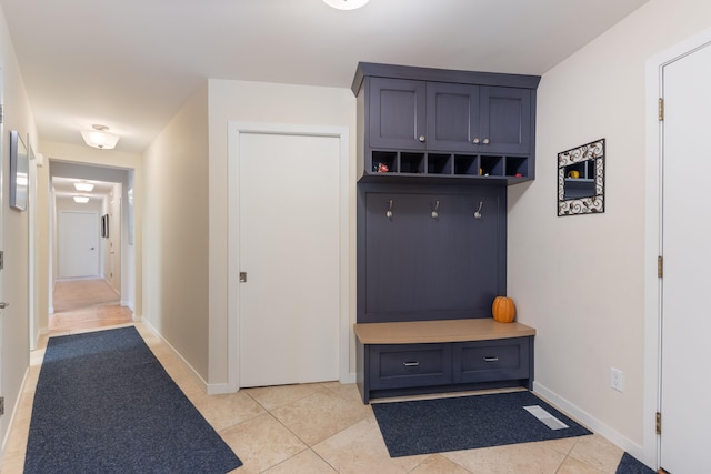 mudroom featuring light tile patterned floors and baseboards