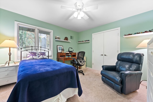 carpeted bedroom featuring a closet, visible vents, and a ceiling fan