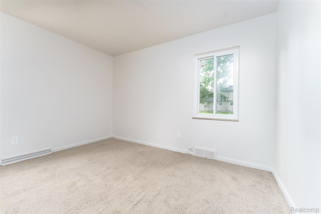 2810 Otsego Rd, Waterford, MI 48328 - unfurnished room featuring carpet flooring and a baseboard heating unit