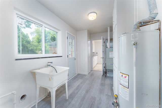 2810 Otsego Rd, Waterford, MI 48328 - bathroom featuring water heater and wood finished floors