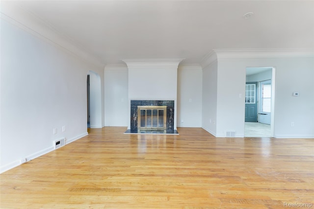 2810 Otsego Rd, Waterford, MI 48328 - unfurnished living room with ornamental molding, light wood-type flooring, arched walkways, and a premium fireplace