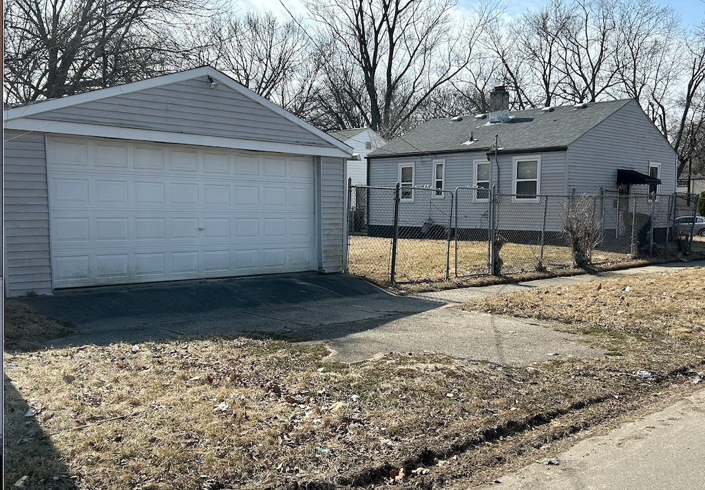 detached garage featuring fence