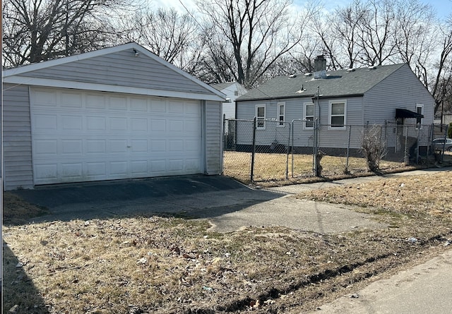 detached garage featuring fence