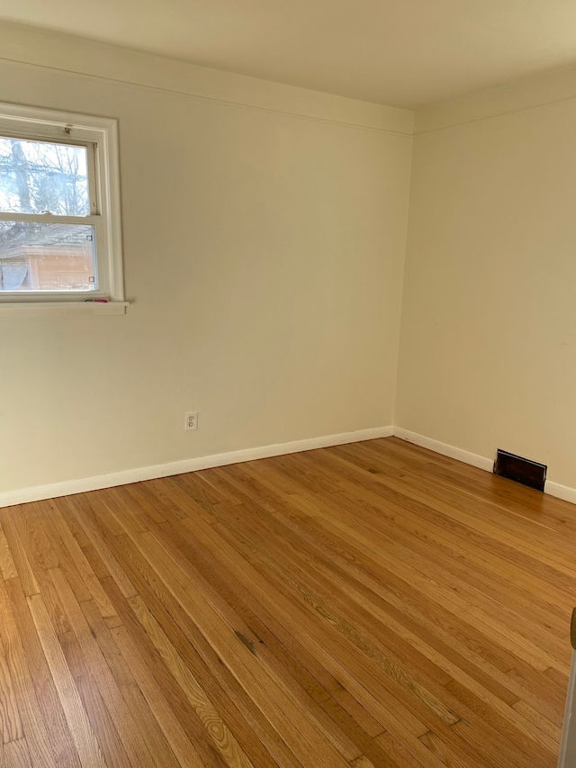 empty room featuring baseboards and wood finished floors