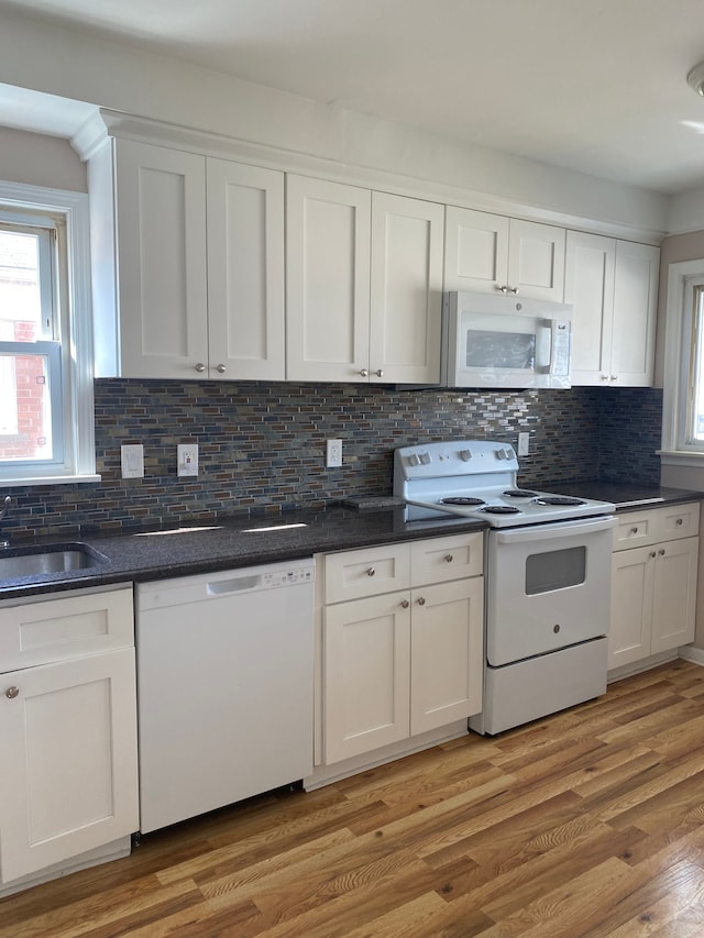 kitchen featuring light wood-style flooring, white appliances, and white cabinets