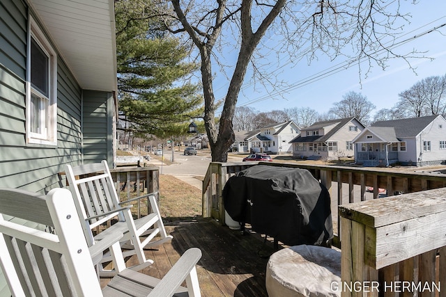 wooden deck featuring a residential view and grilling area