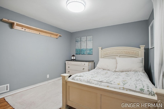 bedroom featuring visible vents and baseboards