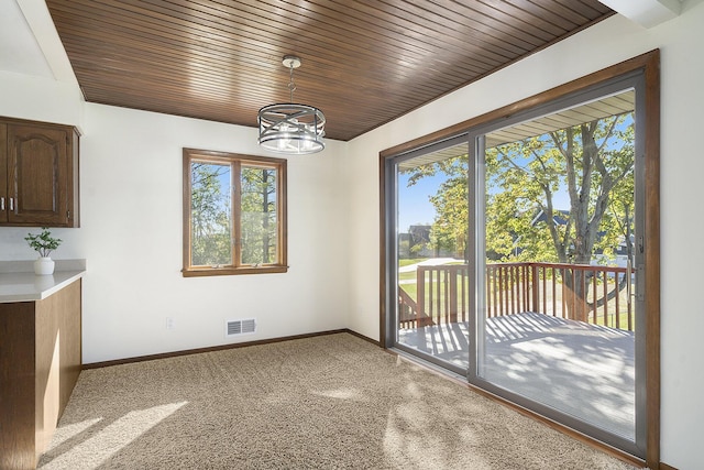 unfurnished dining area featuring an inviting chandelier, plenty of natural light, and baseboards