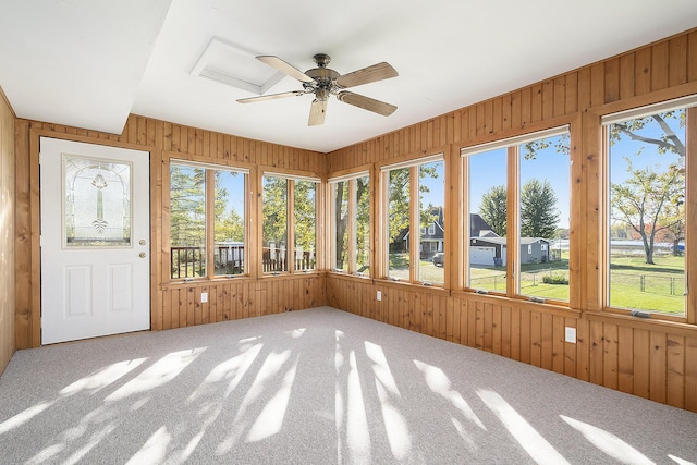 unfurnished sunroom with a wealth of natural light and ceiling fan