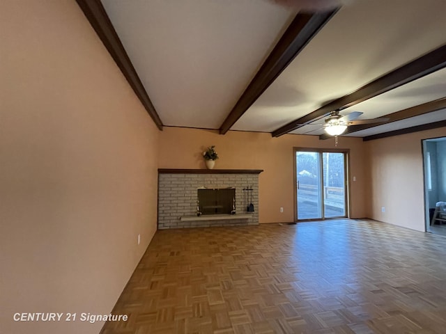 unfurnished living room with beam ceiling, ceiling fan, and a fireplace