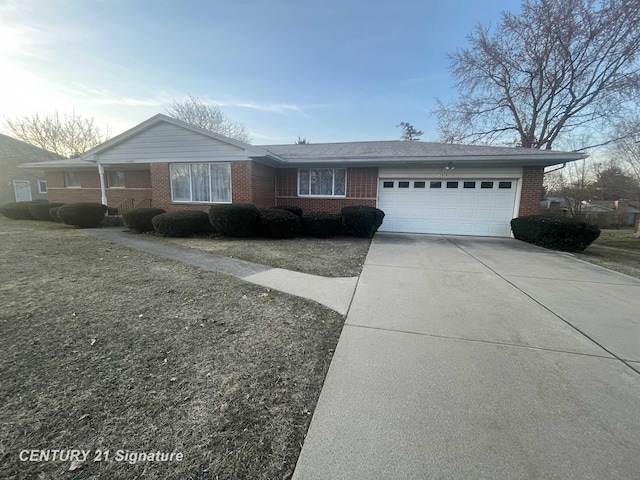 ranch-style home with a garage, brick siding, and driveway