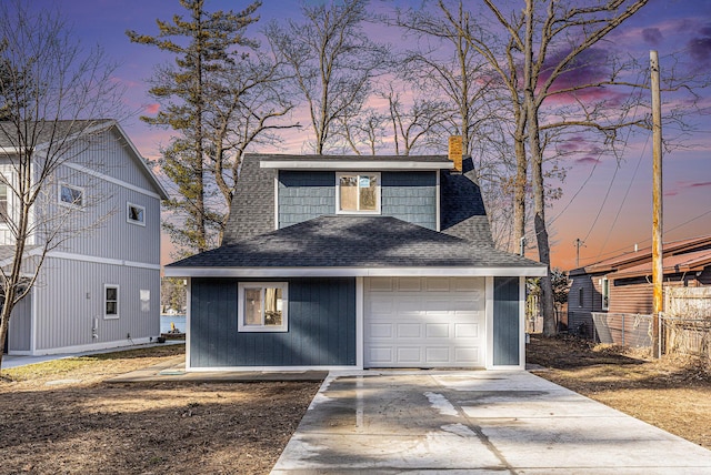 5557 Front St, Newaygo, MI 49337 - garage at dusk with driveway