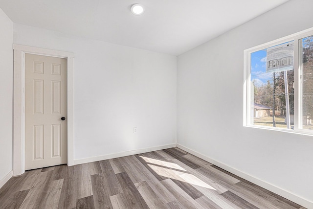 5557 Front St, Newaygo, MI 49337 - spare room featuring baseboards and wood finished floors