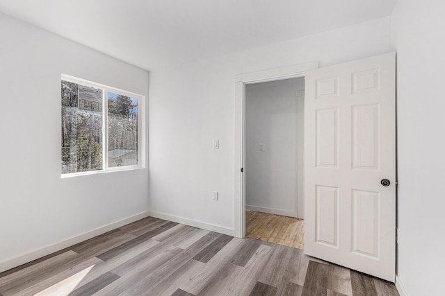 5557 Front St, Newaygo, MI 49337 - unfurnished bedroom featuring wood finished floors and baseboards