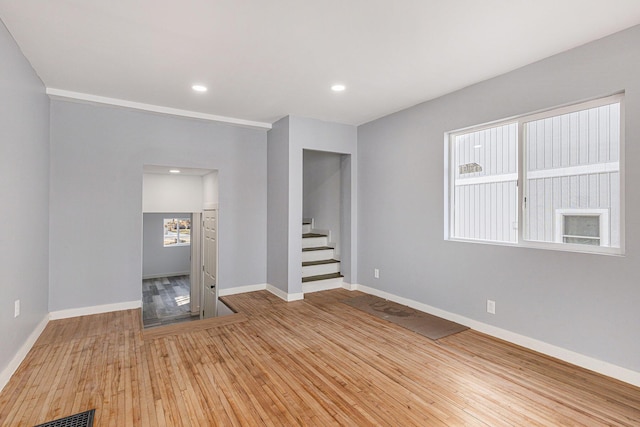 5557 Front St, Newaygo, MI 49337 - unfurnished room featuring visible vents, hardwood / wood-style flooring, recessed lighting, baseboards, and stairs