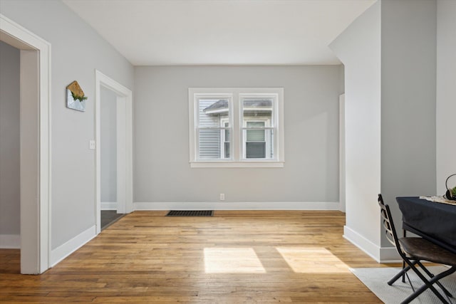 interior space featuring visible vents, baseboards, and wood finished floors