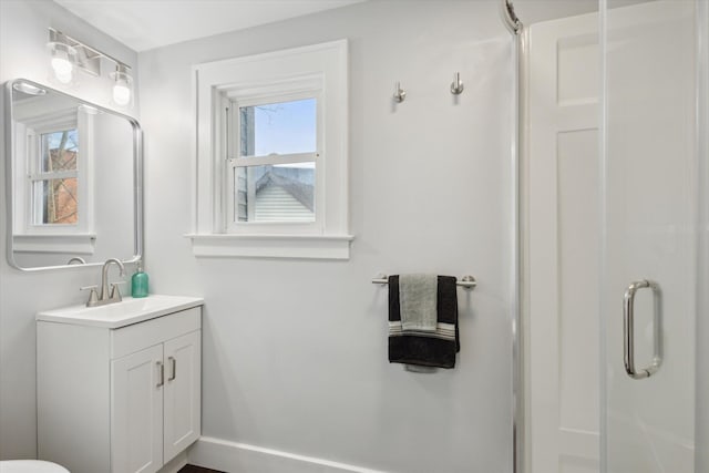 full bathroom with plenty of natural light, a stall shower, and vanity