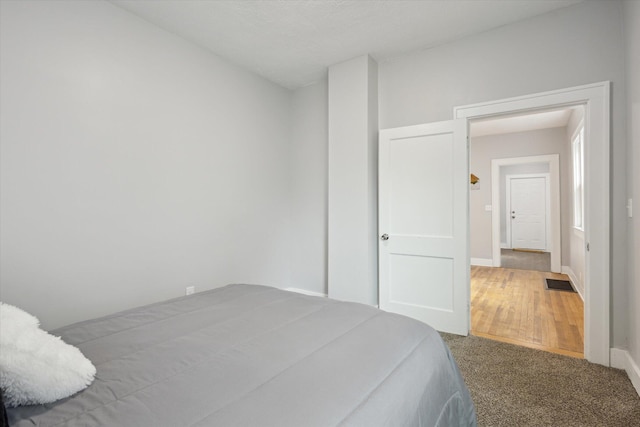 carpeted bedroom featuring baseboards