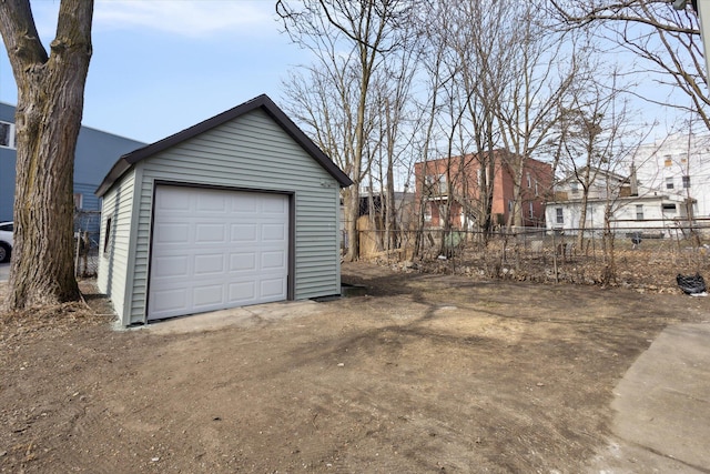 detached garage featuring fence