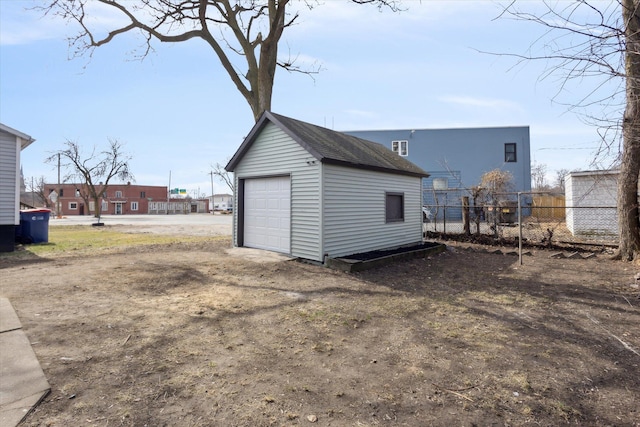 detached garage with driveway and fence