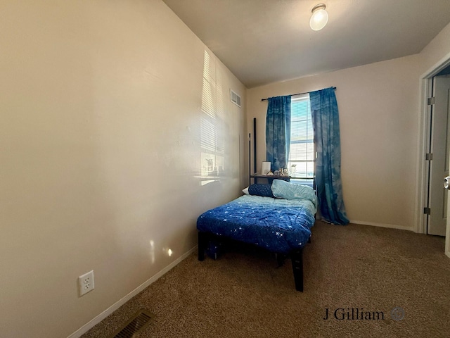 unfurnished bedroom with carpet flooring, visible vents, and baseboards