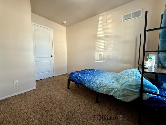 carpeted bedroom with visible vents, baseboards, and lofted ceiling