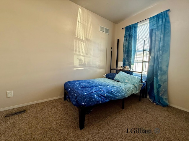 bedroom with visible vents, carpet floors, and baseboards