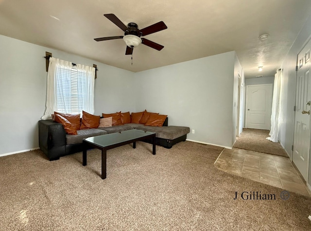 tiled living area with baseboards, carpet, and ceiling fan