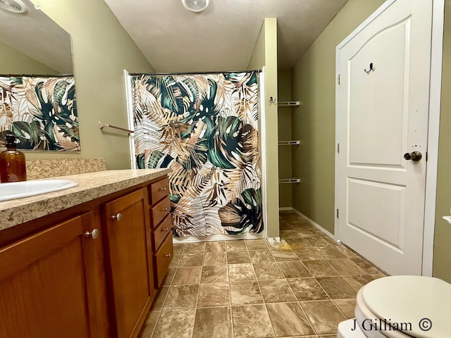 bathroom featuring toilet and vanity