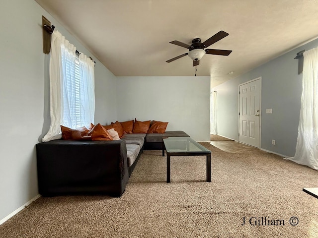 carpeted living room with baseboards, a ceiling fan, and vaulted ceiling