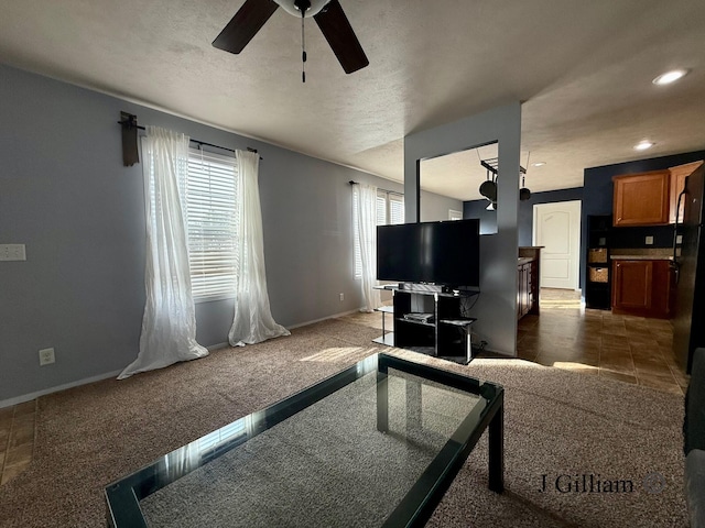 living area featuring baseboards, recessed lighting, ceiling fan, a textured ceiling, and carpet flooring