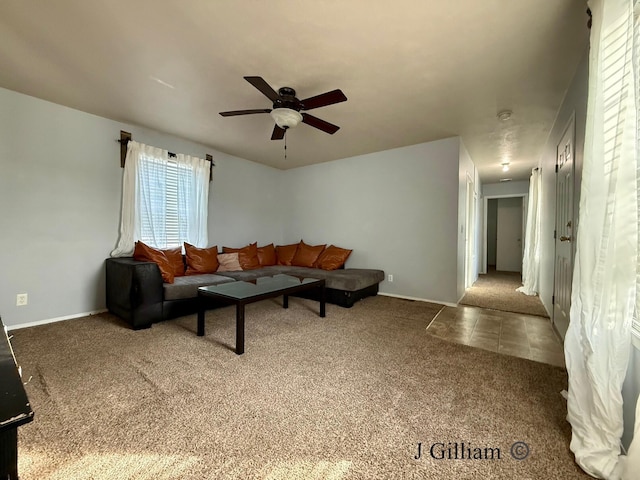 living room with baseboards, carpet floors, and ceiling fan