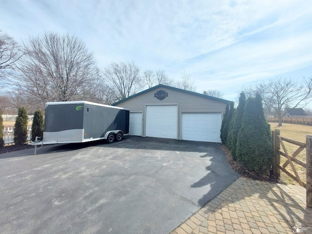 detached garage featuring fence