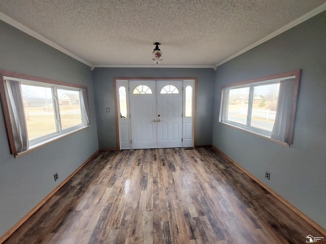 entryway featuring baseboards, a textured ceiling, wood finished floors, and ornamental molding