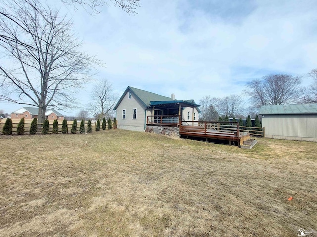 view of yard featuring a deck and fence